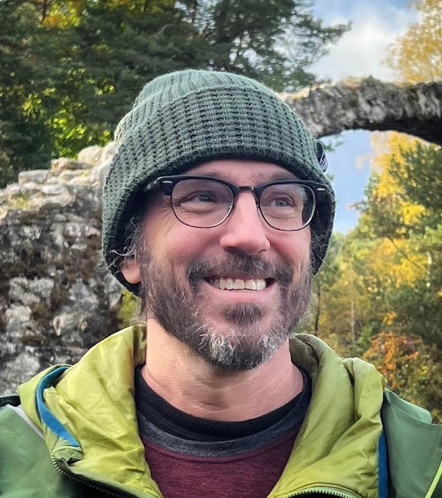 Portrait of Daniel Barton, M.D., outdoors wearing a green toboggan.